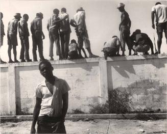 Boy in front of cinderblock wall, Haiti