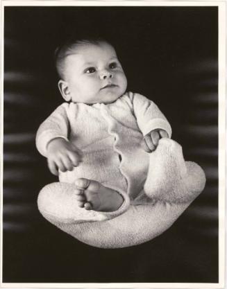 Portrait of baby playing with feet