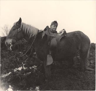 Farm boy mounting a horse