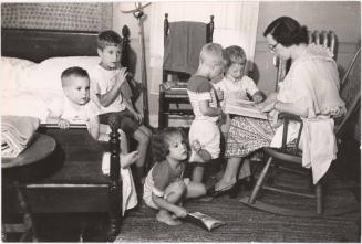 Mother reading to group of children