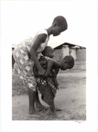 Sharing the knowledge of how to carry baby sister in Oda, Ghana