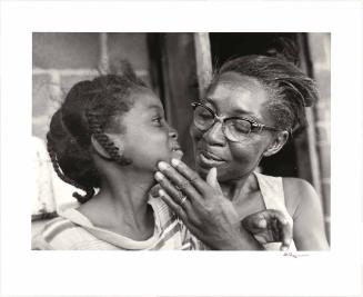 Grandmother caressing granddaughter’s face, Alabama, USA