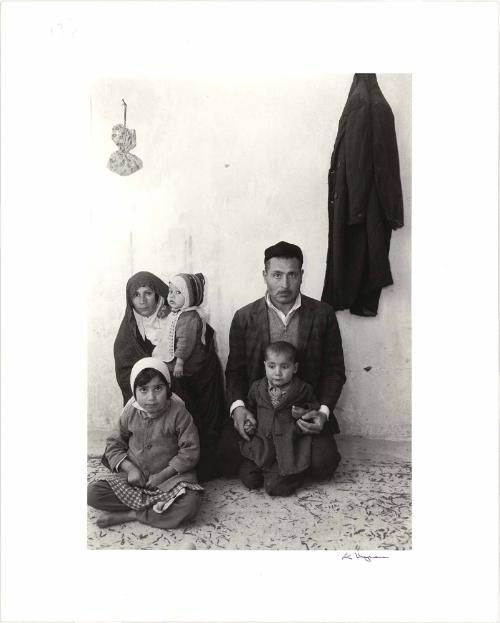 Family portrait in Teheran, in a cold, one room house, Iran