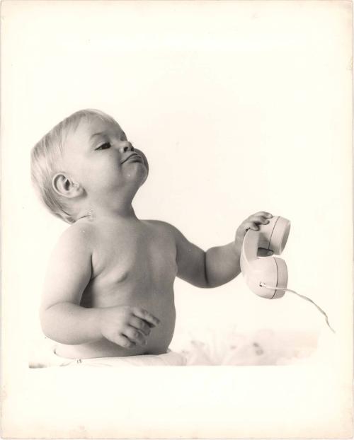 Portrait of baby playing with telephone