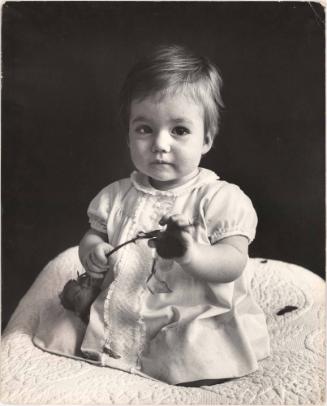 Portrait of baby girl with rose