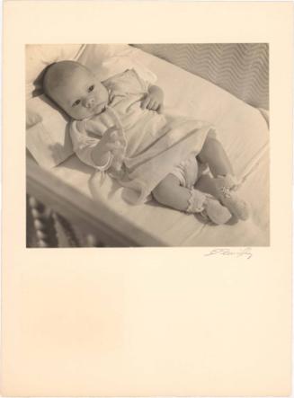 Portrait of baby lying in a crib