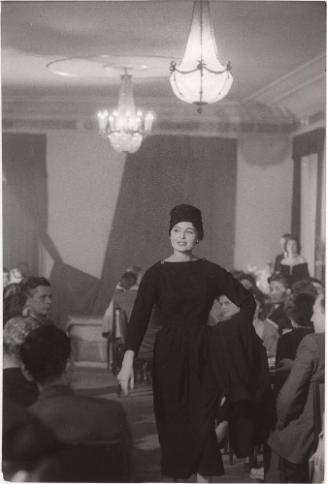 Woman modeling a dark dress and hat, Poland