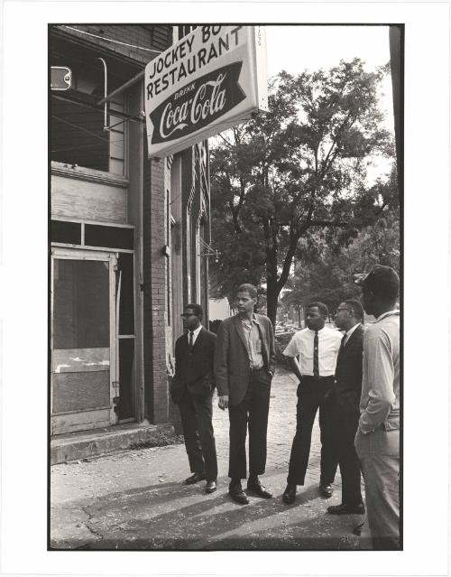 Jimmy Hicks, Julian Bond, John Lewis, and Jeremiah X stand across the street from the bombed church