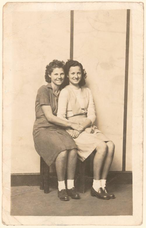 Myrtle Newman and Rosie Long [Two seated women embracing, striped background]