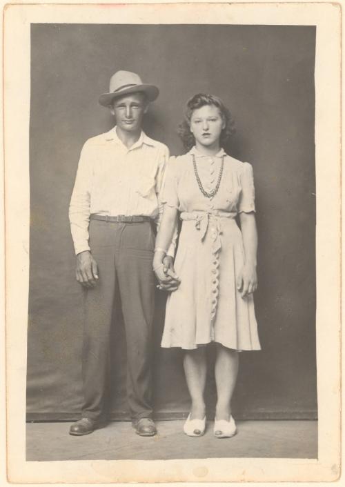 Standing man and woman holding hands