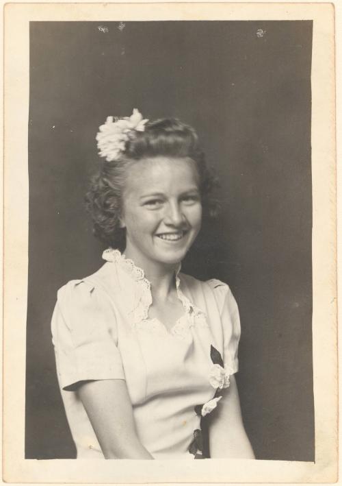 Smiling young woman with bow in hair