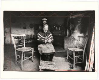 [Elderly woman knitting at home, Sicily, Italy]