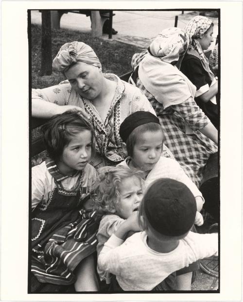 [Hassidic children and mother sitting on a bench, New York City]