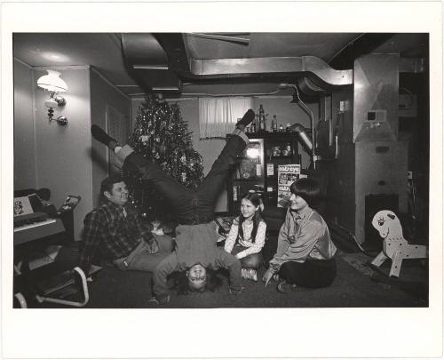 Christmas, A Policeman, his Family and a Neighborhood Friend in the Basement Playroom of their House