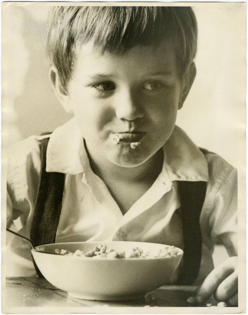 Portrait of young boy eating cereal