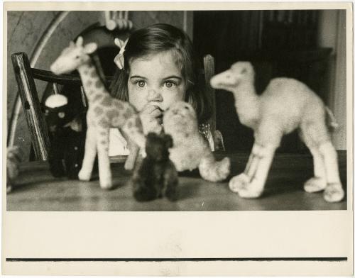 Portrait of young girl admiring toys