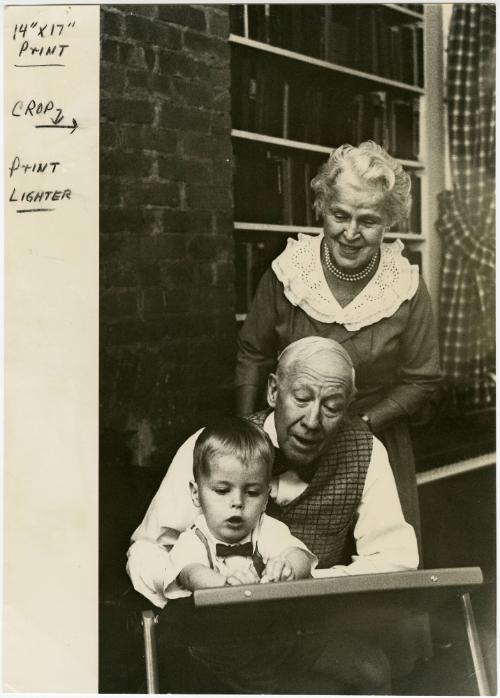 Elderly couple playing with grandson