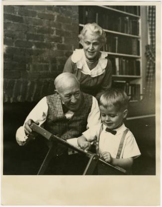 Elderly couple playing with grandson