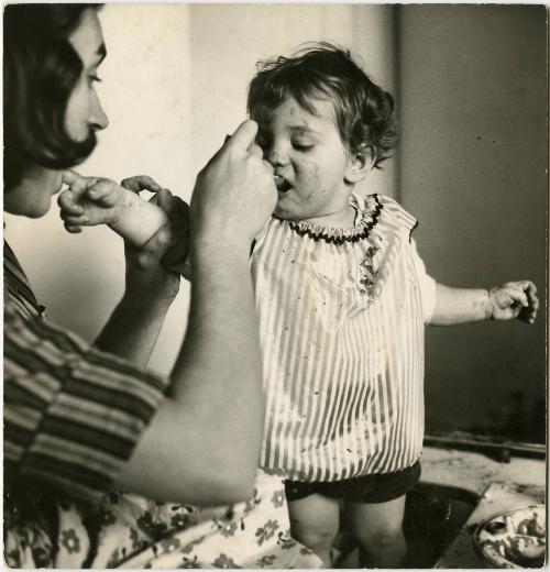 Mother feeding baby with a spoon