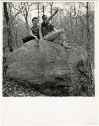 Father and boy with glasses sitting on large rock, from the series Big Brother