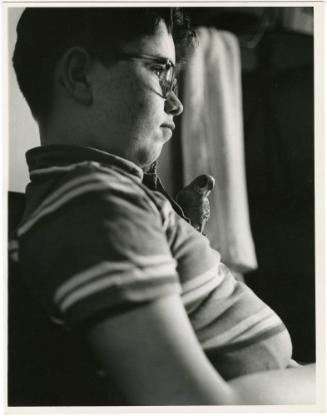 Boy with glasses with parakeet perched on his chest, from the series Big Brother