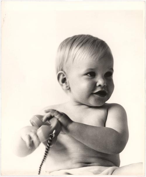 Portrait of baby playing with telephone