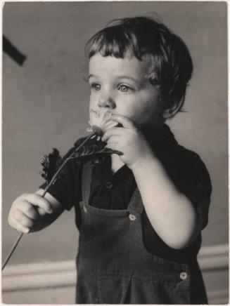 Portrait of toddler holding plastic flower