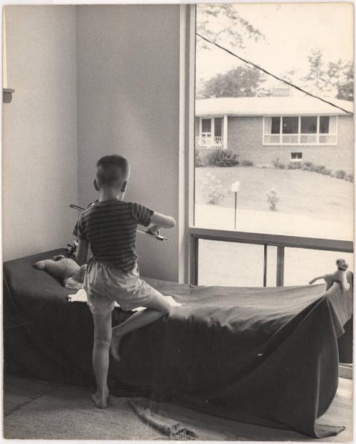 Portrait of boy practicing violin in bedroom