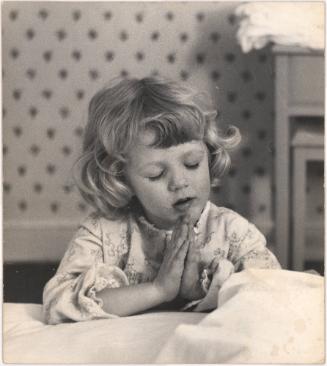 Portrait of young girl praying