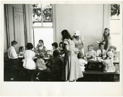 Children eating at a long table